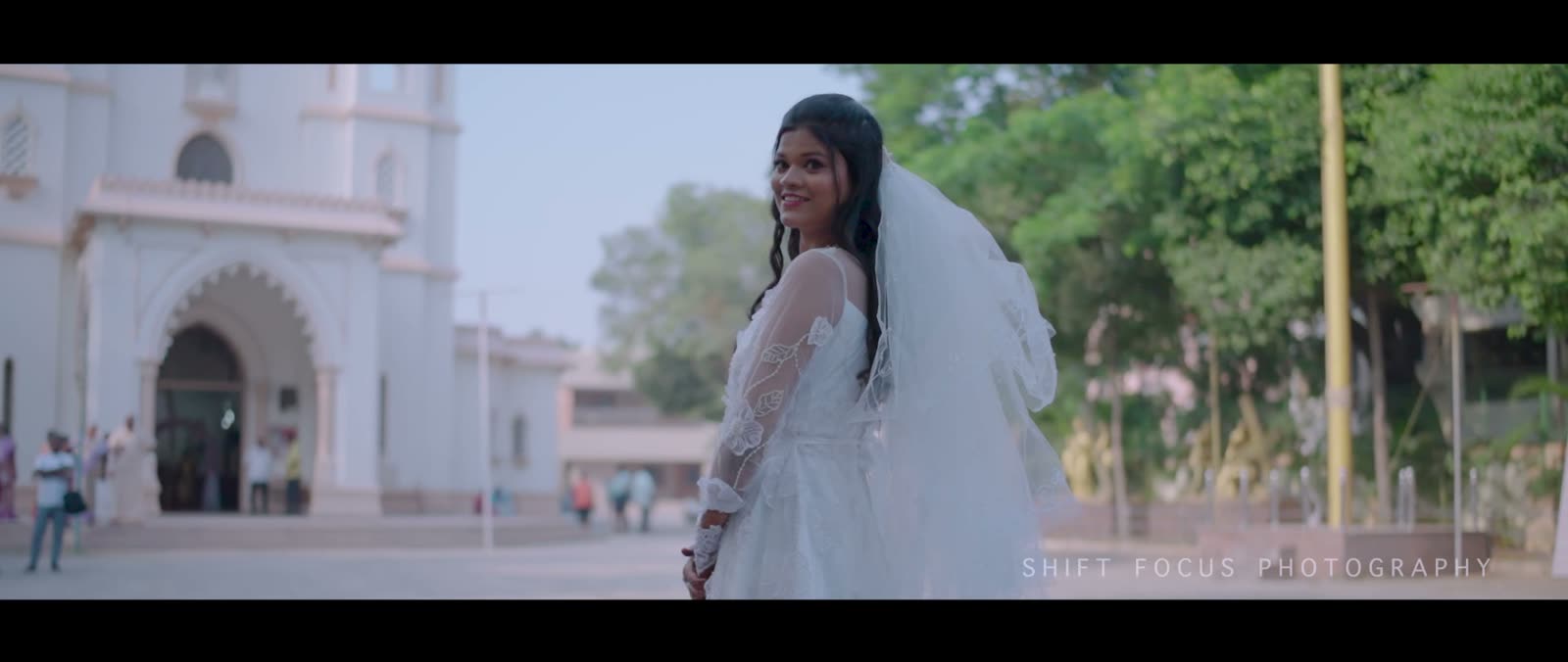 Laila in her bridal gown outside the church, still from Naveen and Laila's wedding film