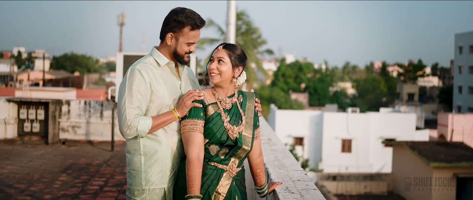Siddharth and Yugapriya on a rooftop at golden hour, still from their wedding film