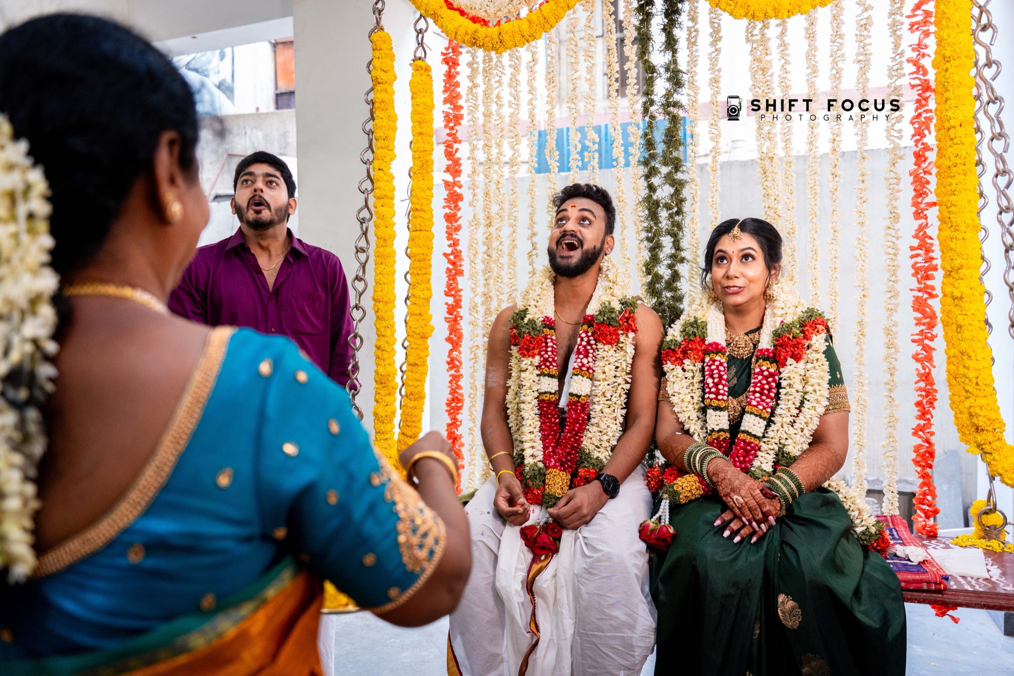 Couple garlanded at the mandap