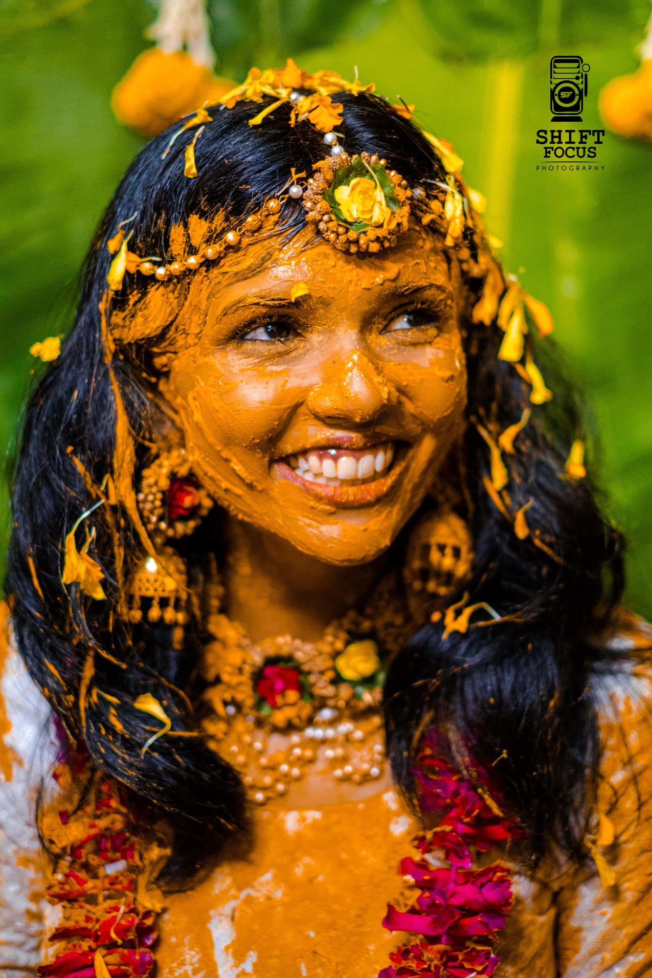Bride laughing through the haldi