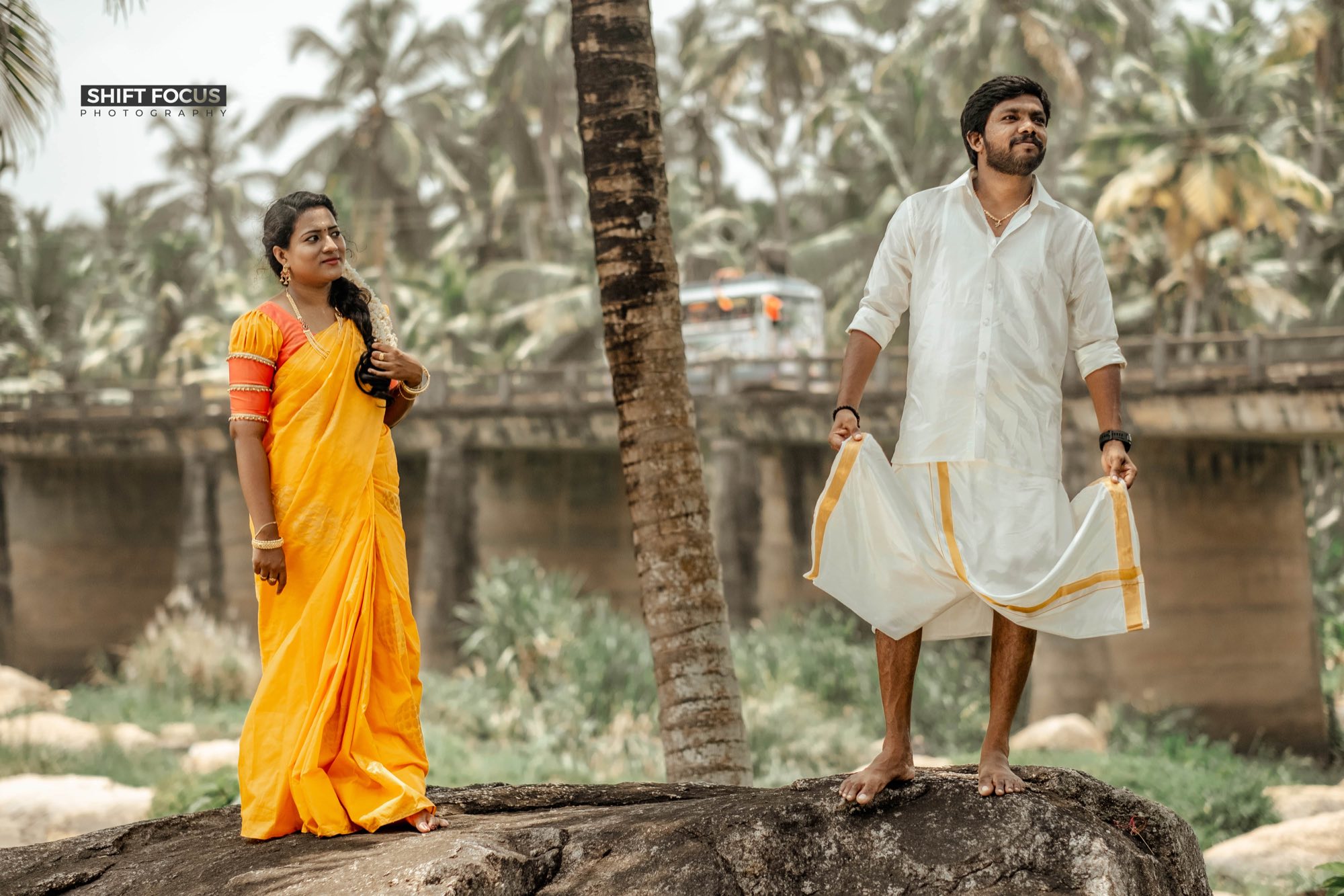 Couple walking through a palm grove
