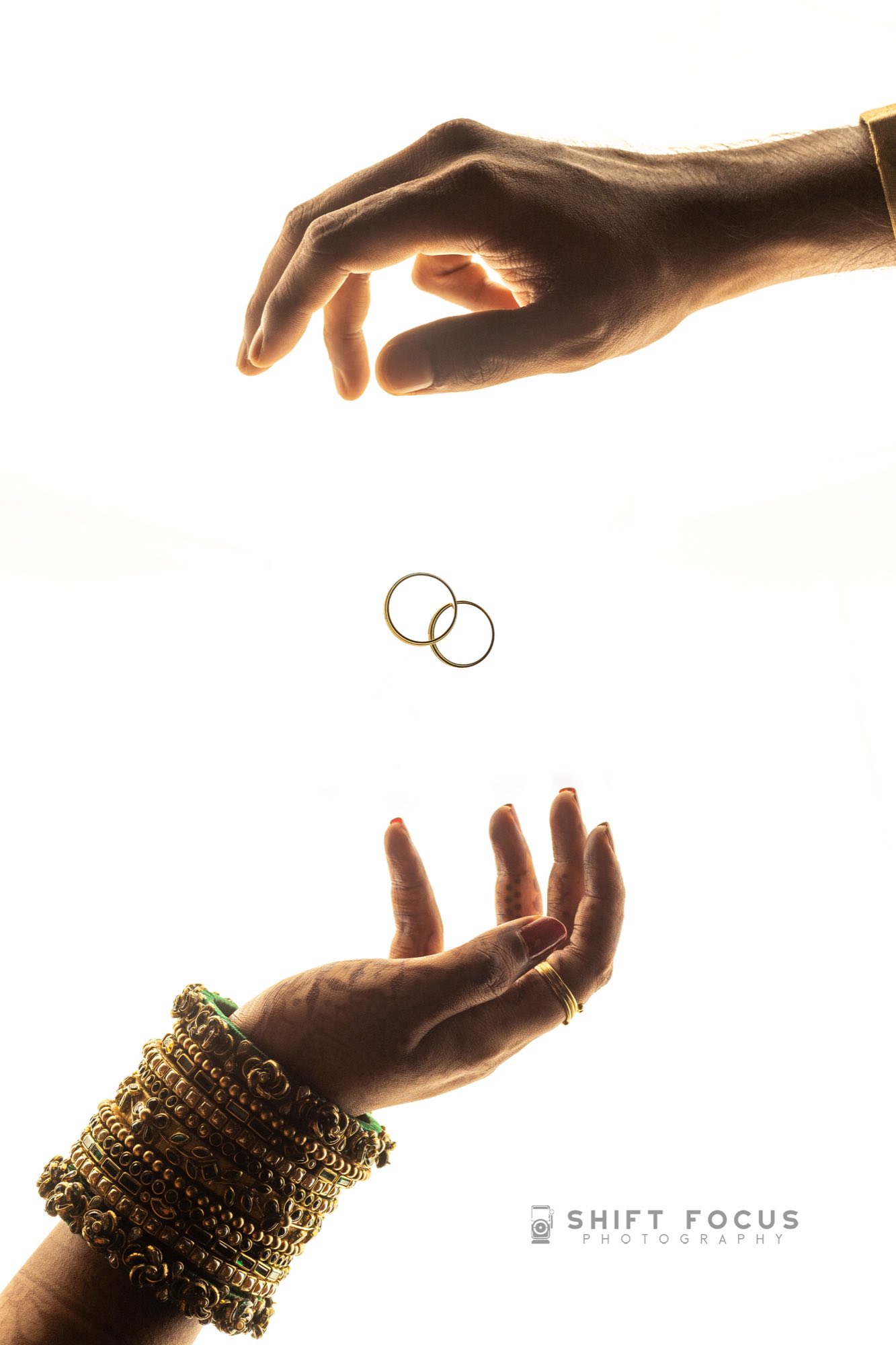 Hands holding two wedding rings