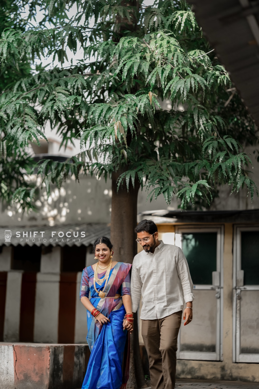 Couple strolling beneath a neem tree